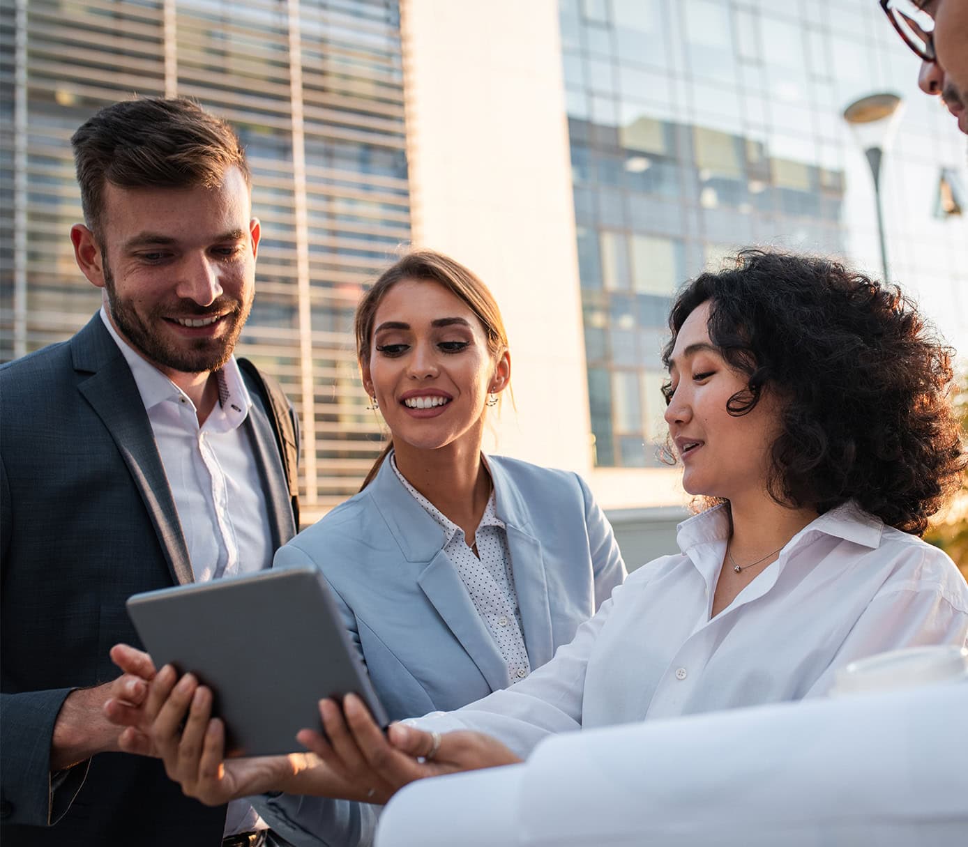 coworkers standing outside in front of office